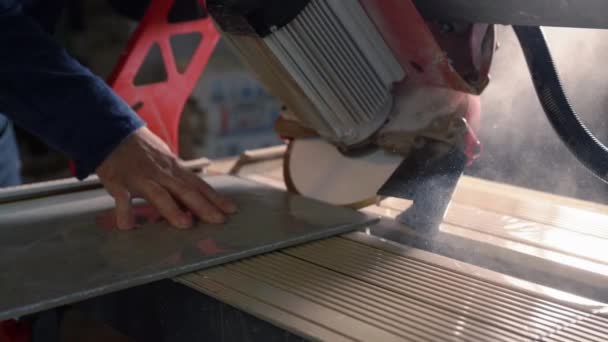 工人们用一个大的工业圆锯小心地切割墙板或瓷砖 刀片浸入水中 双手紧贴着 — 图库视频影像