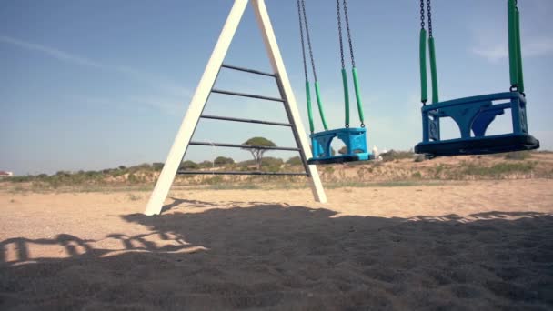 Nízký úhel pohledu na dvojitý A-frame swing na pláži — Stock video