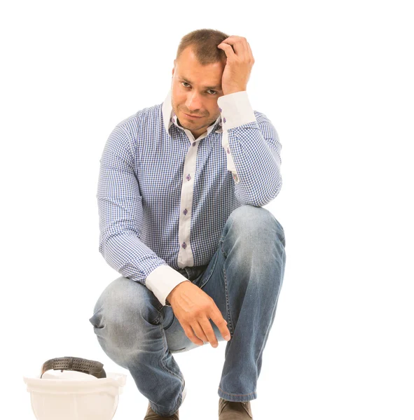 Crouching Man with Hard Hat Scratching Head — Stock Photo, Image