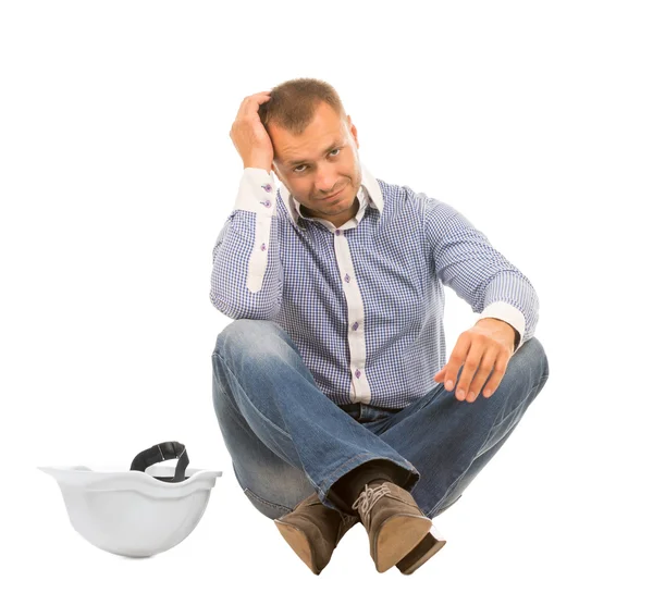 Man with Hard Hat Sitting and Leaning Head in Hand — Stock Photo, Image