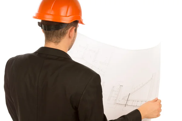 Young architect studying a building blueprint — Stock Photo, Image