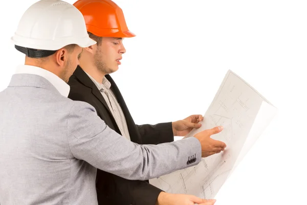 Architect and engineer looking at a blueprint — Stock Photo, Image