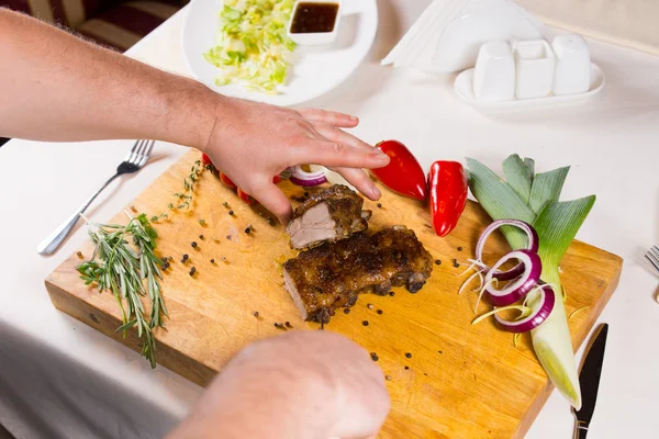 Slicing Appetizing Cooked Meat on Wooden Table — Stock Image Slicing Appetizing Cooked Meat on Wooden Table Royalty Free Stock Photos
