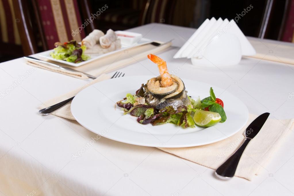 Gourmet Seafood Dish on Vegetables with Lemon