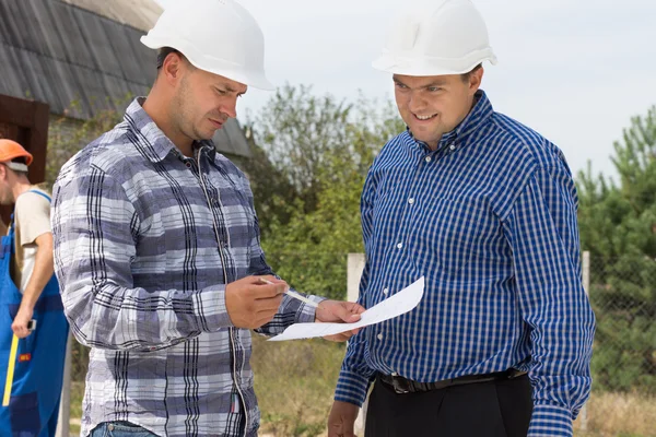 Two architects checking specifications — Stock Photo, Image