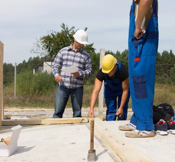 Equipo de trabajadores en una obra de construcción — Foto de Stock