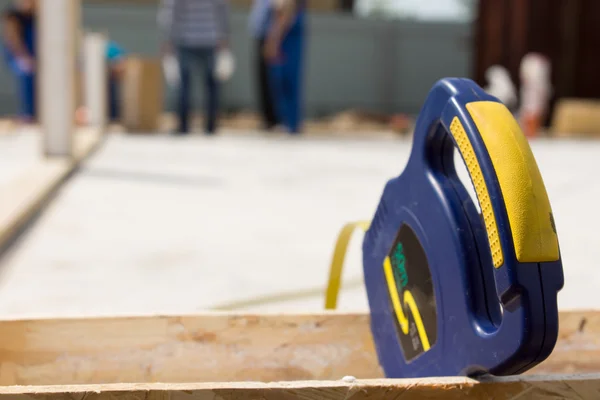 Builders tape measure on a building site — Stock Photo, Image