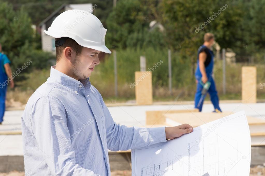 Engineer checking specifications on a plan
