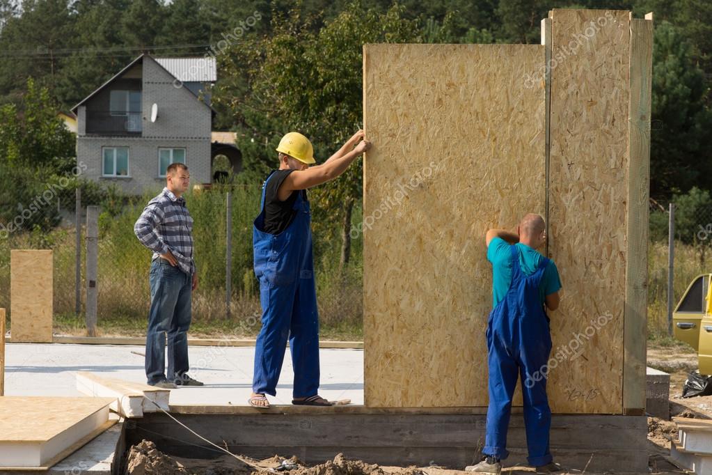 Builders erecting wall panels Stock Photo by ©Vaicheslav 56493015