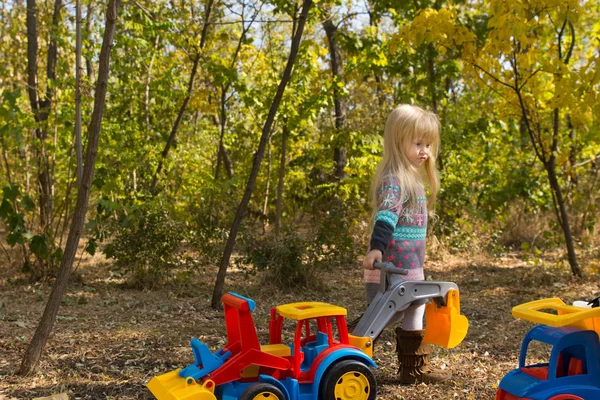 Fille mignonne avec des véhicules de construction colorés — Photo