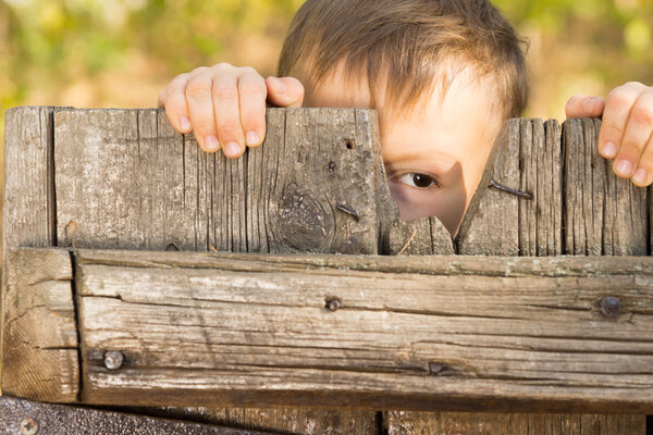 Little boy playing peek a boo