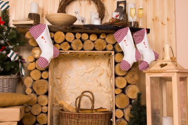 Christmas Stockings Hanging from Rustic Mantle clipart