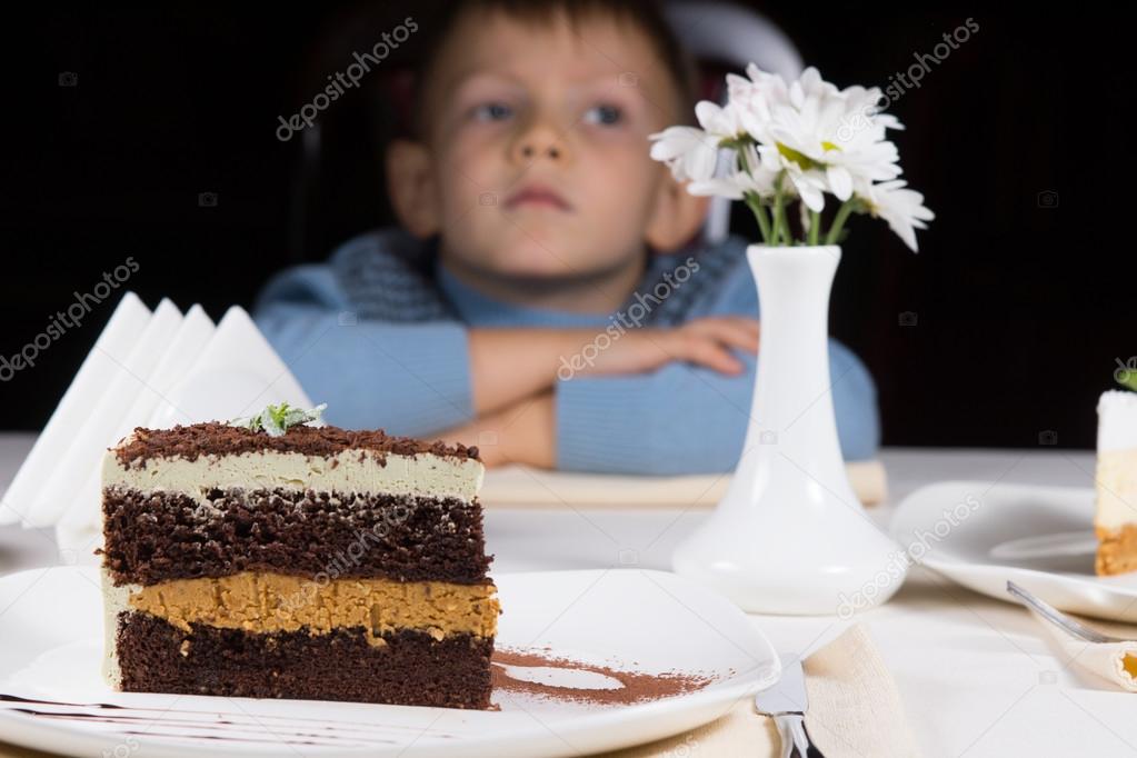 Little boy waiting patiently for cake