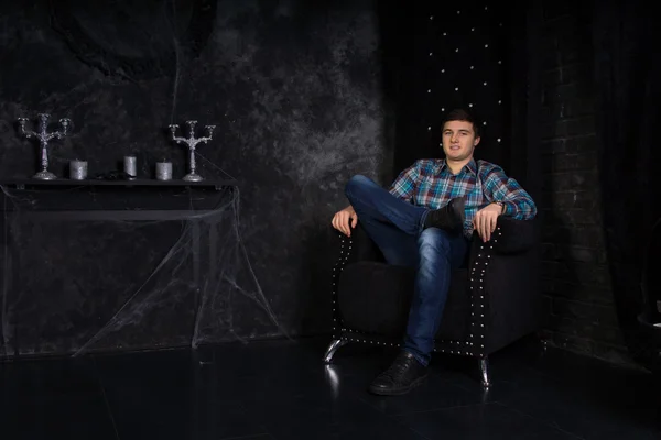 Man Sitting in High Back Chair in Haunted House — Stock Photo, Image