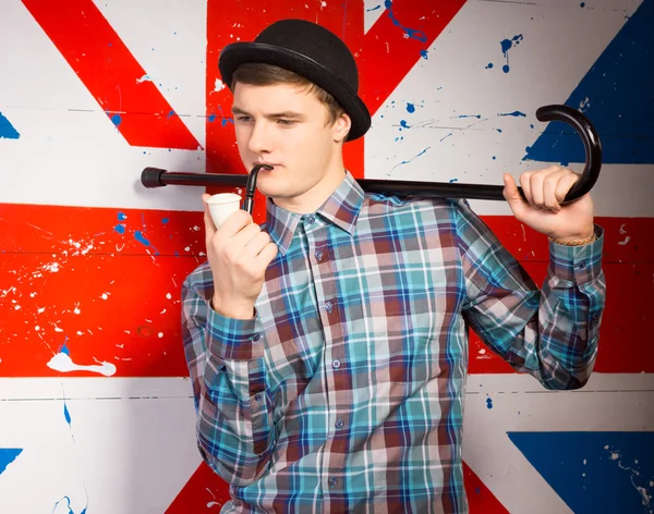 Smoking Young Man with Cane on his Shoulder — Stock Photo, Image