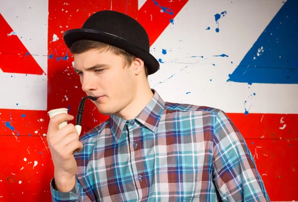 Typical English gentleman in a bowler hat and pipe — Stock Photo, Image