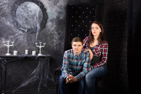 Young Couple Sitting in Creepy High Back Chair — Stock Photo, Image