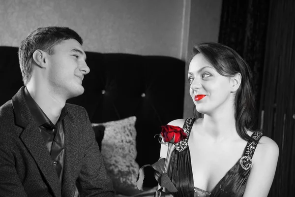 Jovem casal feliz com flor de rosa vermelha — Fotografia de Stock