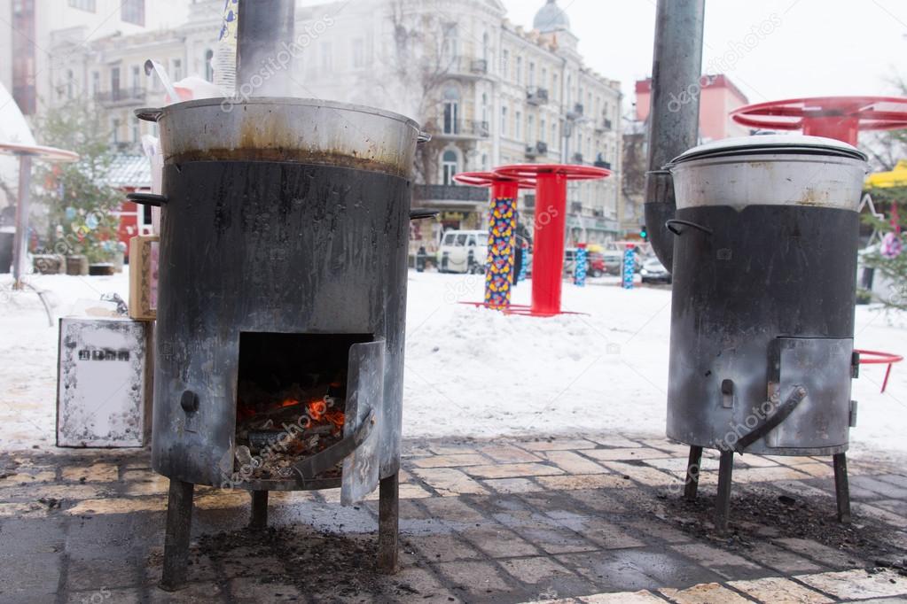 Two portable potbelly stoves for cooking outdoors