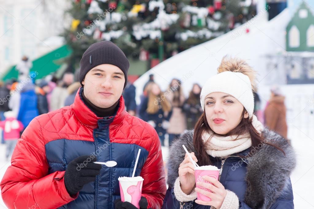 Young couple enjoying a Christmas carnival