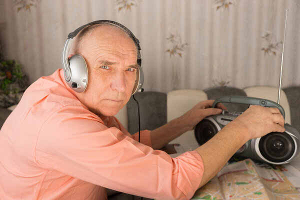 Elderly Listening Radio While Looking at Camera
