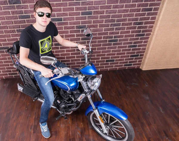 Hombre guapo con sombras en su motocicleta — Foto de Stock