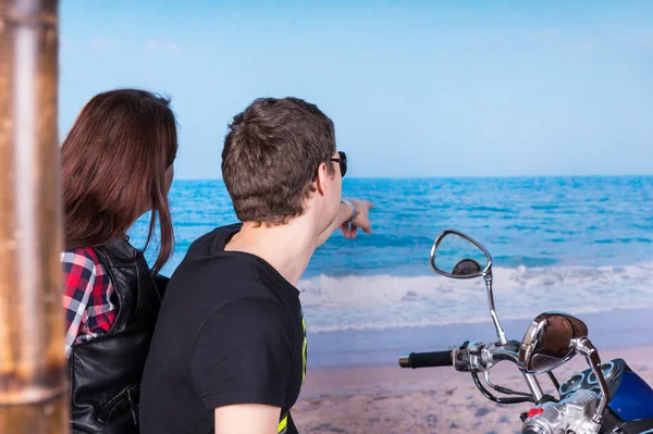 Sweethearts op een motorfiets kijken naar de Oceaan — Stockfoto