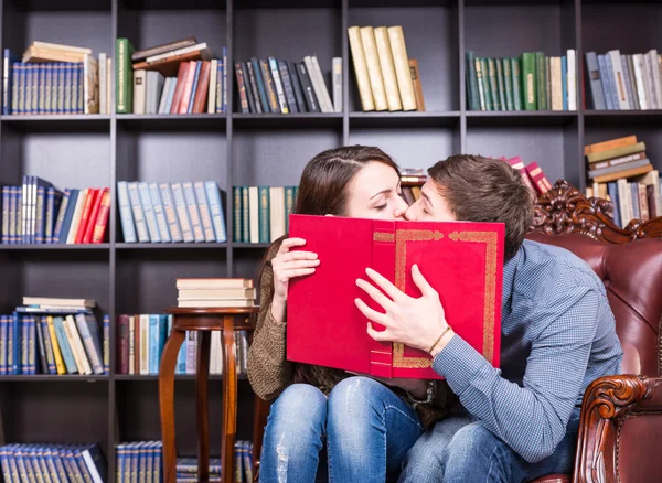 Romantic young couple sneaking a kiss — Stock Photo, Image