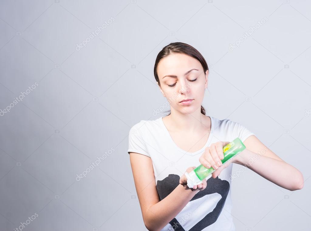 Woman Putting Liquid Facial Cleanser on a Cotton