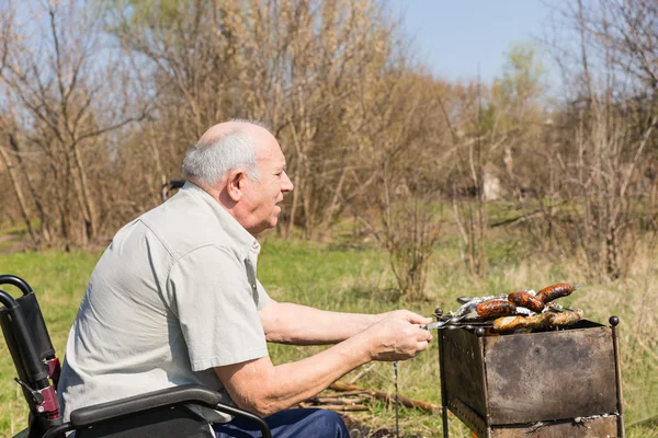 Hombre sentado Anciano preparando comida para comer afuera — Foto de Stock