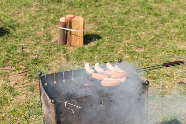 Grilling Tasty Meat Sausages on Barbecue Grill — Stock Photo, Image