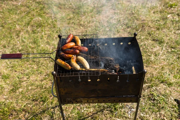 Slightly Cooked Meat Sausage on Barbecue Grill — Stock Photo, Image