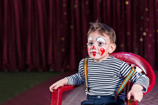 Kid with entertaining skills and clown make-up