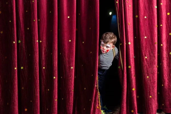 Anxious young actor looking out from the curtains — Stock Photo, Image