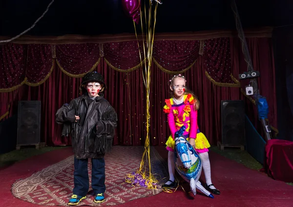 男孩与女孩骑着马气球舞台上的小丑 — 图库照片