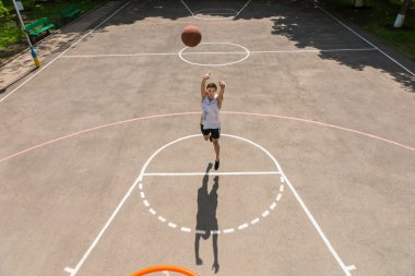 Young Man Making Free Throw on Basketball Court clipart