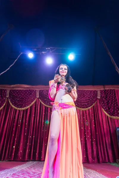 Exotic Belly Dancer Standing on Stage with Snake