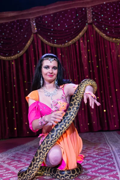 Exotic Dancer Kneeling on Stage with Large Snake — Stock Photo, Image