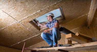 Builder Inspecting Skylight in Unfinished House clipart
