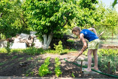 Bir sebze bahçesinde çalışan genç kız