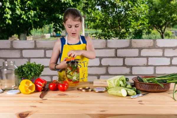 Young country girl bottling vegetables — Stock Photo, Image