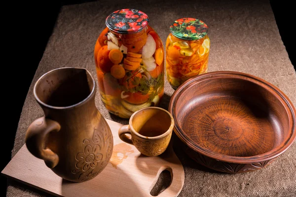 Jars of Pickles on Table with Wooden Handicrafts — Stock Photo, Image