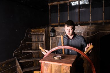 Portrait of Young Man Navigating Wooden Ship clipart