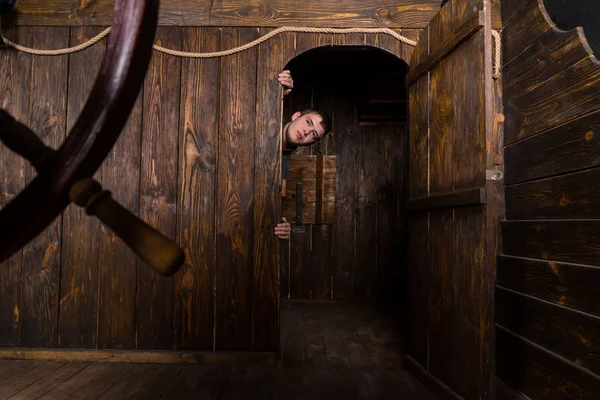 Young Man Peering Out Doorway of Wooden Ship — Stock Photo, Image