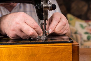 Male Hands Threading Needle of Sewing Machine