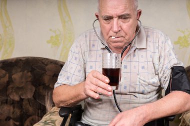 Old Bald Man with BP Apparatus Taking his Medicine