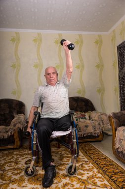 Disabled old men doing exercises with dumbbells