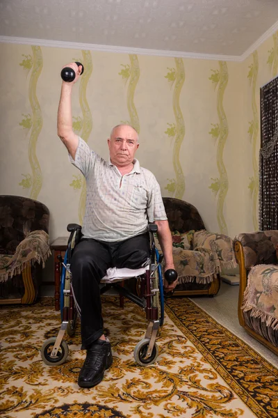 Disabled senior men doing exercises with dumbbells
