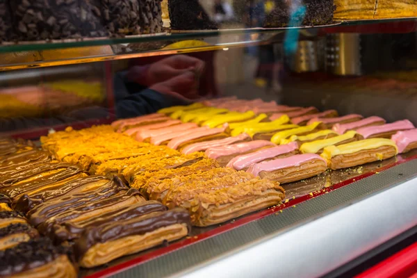 Decadent Iced Pastries on Display in Bakery Window — Stock Fotó