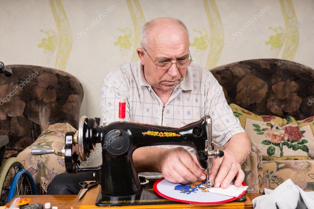 Senior Man Doing Needlepoint on Sewing Machine Stock Photo by